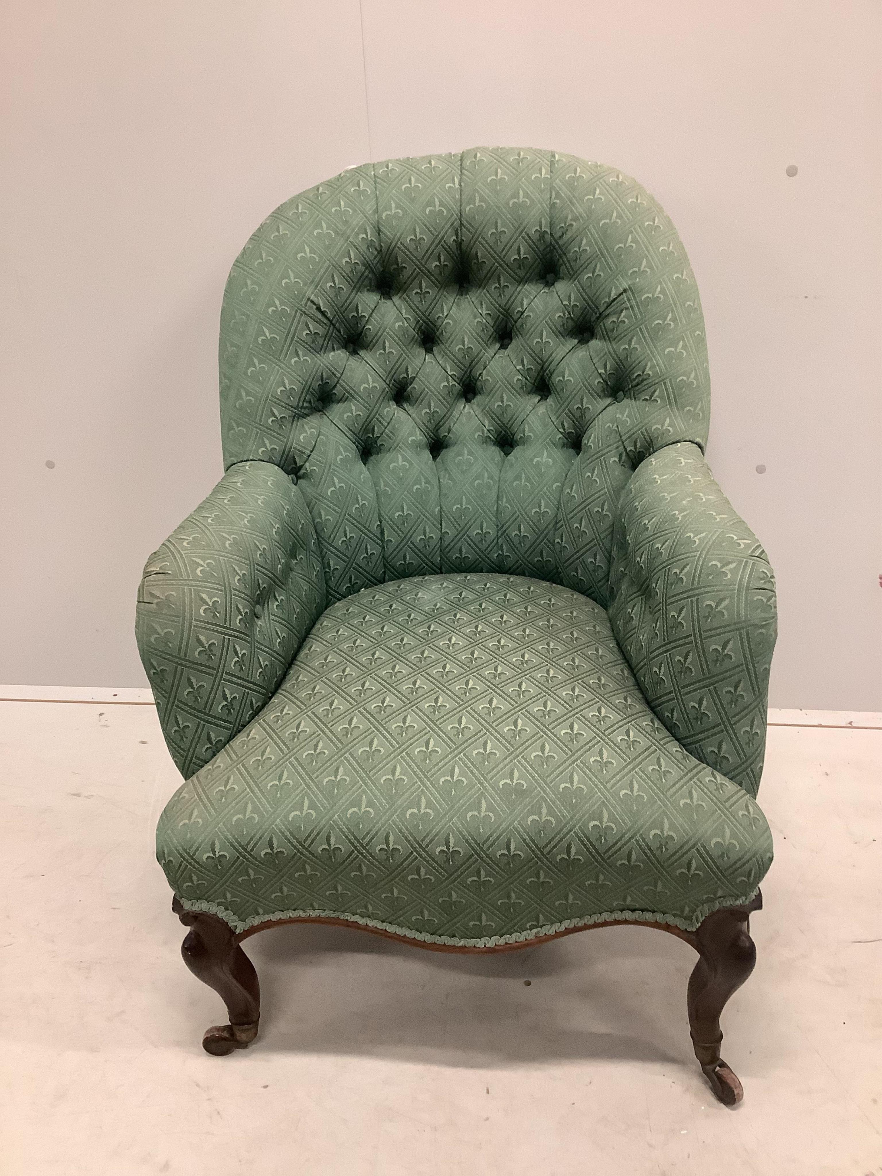 A Victorian rosewood spoonback armchair, width 68cm, depth 68cm, height 90cm. Condition - fair